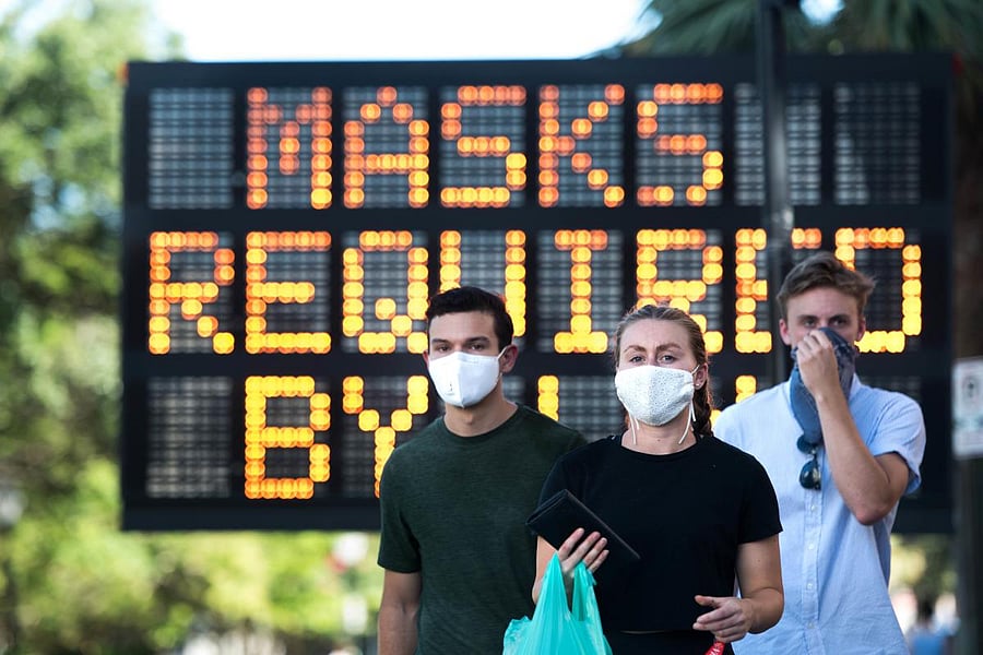 People wearing protective face masks. Credit: AFP