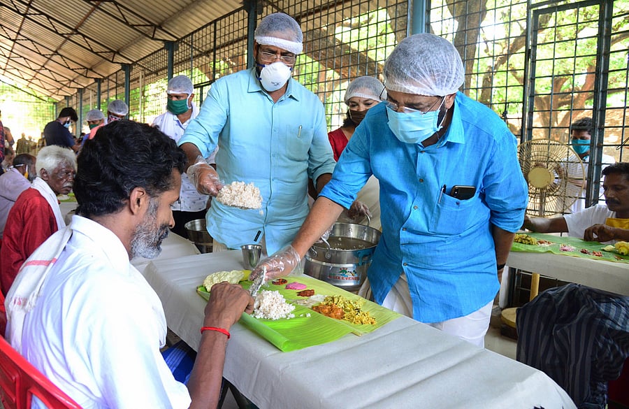Thiruvananthapuram: Devaswom and Tourism Minister Kadakampally Surendran serves food among homeless people on the occasion of Vishu festival during a nationwide lockdown. Credits: PTI Photo