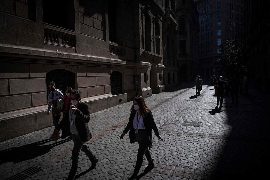People wearing face masks walk along Plaza de Armas square in Santiago amid the coronavirus pandemic. Credit: AFP File Photo