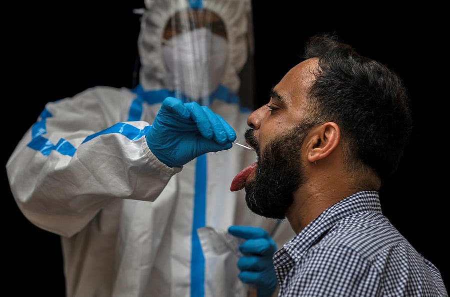 A medical worker takes a sample for a Covid-19 test. Credit: Reuters