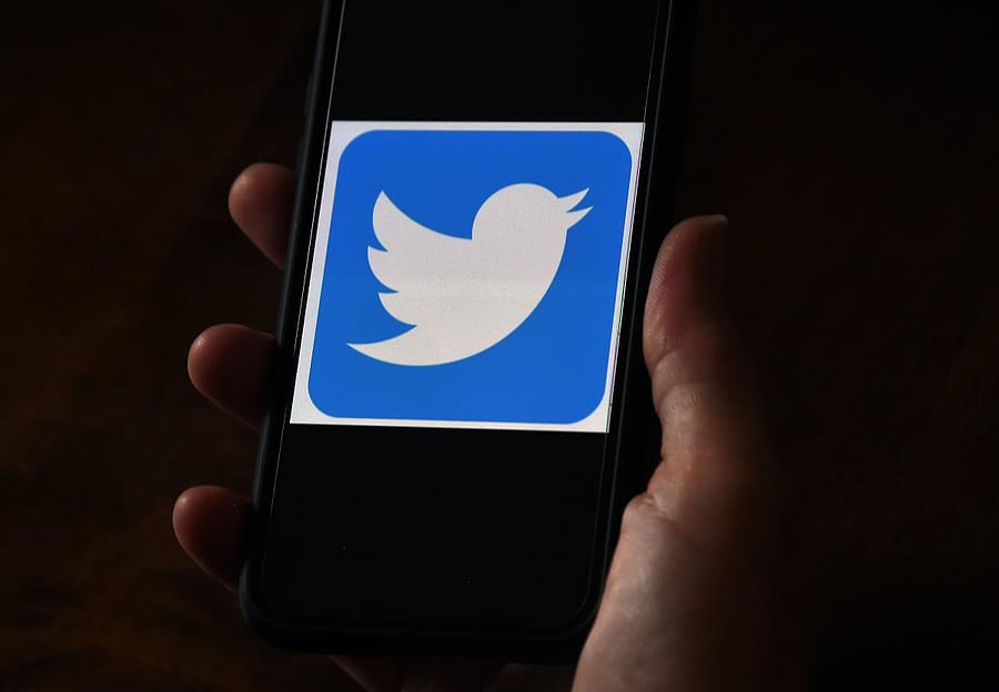 (FILES) In this file photo illustration, a Twitter logo is displayed on a mobile phone on May 27, 2020, in Arlington, Virginia. - Twitter says hackers "manipulated" some of its employees to access accounts in a high-profile attack on the social media comp