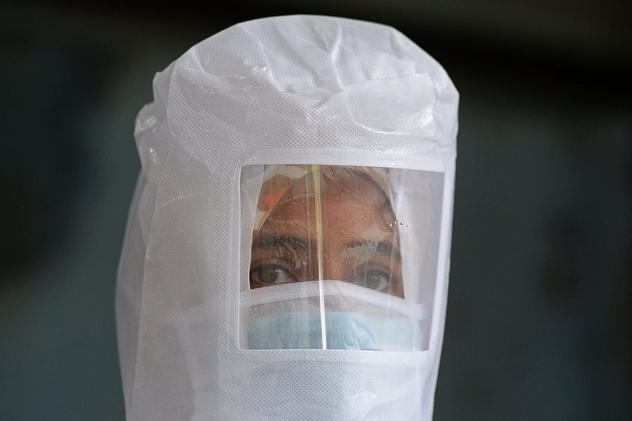 A health worker wearing Personal Protective Equipment (PPE) gear watches at a free testing centre for the COVID-19. Credits: Reuters Photo