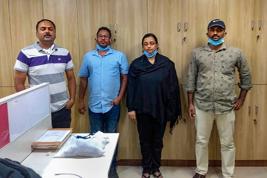 Kerala gold smuggling case accused Swapna Suresh and Sandeep Nair (both in middle) after they were arrested by the National Investigation Agency in Bengaluru, Karnataka, Saturday, July 11, 2020. Credit: PTI Photo
