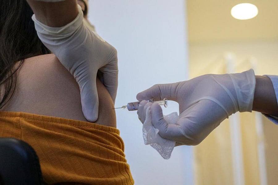 Handout picture released by the Sao Paulo State Government press office showing a volunteer receiving the COVID-19 vaccine during the trial stage of the vaccine produced by the Chinese company Sinovac Biotech at the Hospital das Clinicas (HC) in Sao Paulo state, Brazil, on July 21, 2020. Credit: AFP Photo