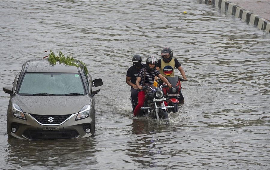 Vehicles ply on a waterlogged street during heavy rain, in New Delhi. Credit: PTI