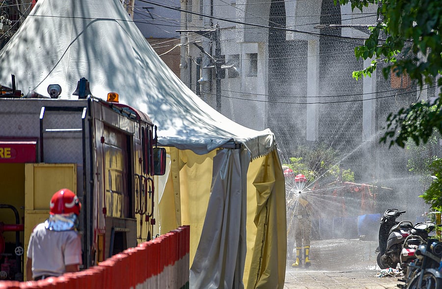 Firefighters spray disinfectants at a locality near Nizamuddin mosque. Credit: PTI
