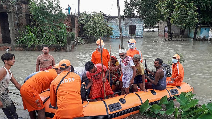 NDRF personnel rescue villagers from flood-affected areas, in Gopalganj district. Credit: PTI/file