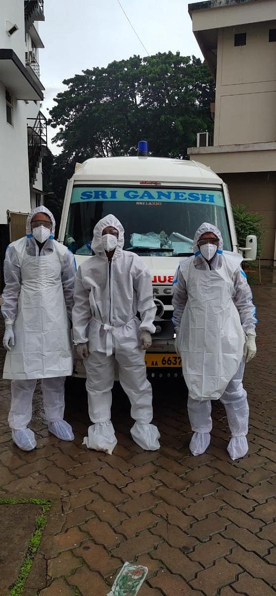 The staff members of Sri Ganesh Ambulance get ready to ferry the body of a Covid-19 victim.