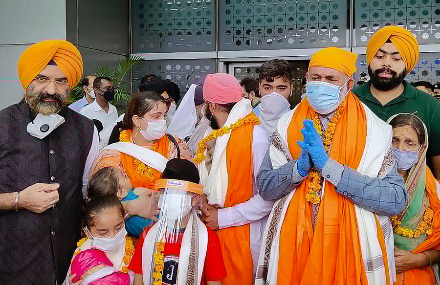 SAD leader Manjinder Singh Sirsa welcomes first batch of Afghan Sikh families who faced persecution & terror attacks there and are now given shelter in India. Credit: PTI Photo