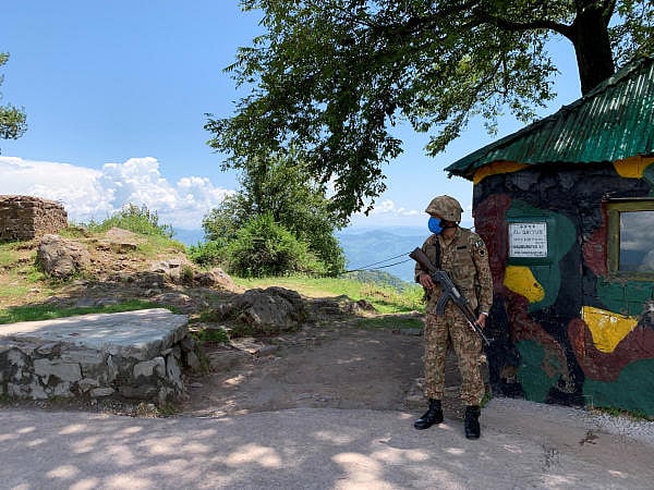 Pakistan Army soldier stands guard at a hilltop post during a trip organised by the army, near the Line of Control. Credit: Reuters
