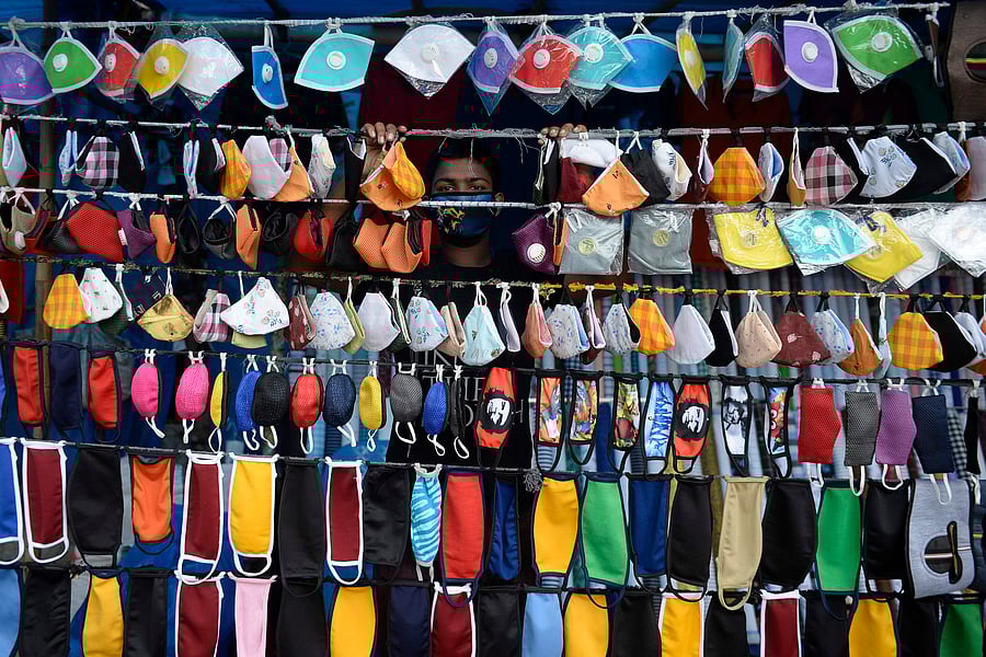 A vendor arranges facemasks to sell on a roadside in Hyderabad. Credit: AFP