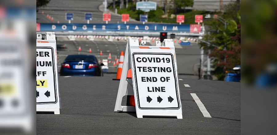 A sign reads "COVID-19 Testing End Of Line" outside a coronavirus testing site in a parking lot at Dodgers stadium in Los Angeles, California. Credit: AFP Photo