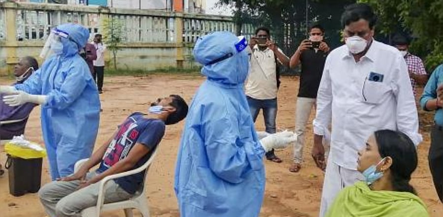 MLA Anbalagan inspects Covid-19 testing of residents being conducted by health workers at Oupalam in Puducherry. Credit: PTI Photo