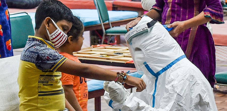 A nurse ties 'rakhi' on the wrist of a patient on the occasion of 'Raksha Bandhan', at CWG Village Covid-19 care centre near Akshardham, in New Delhi. Credit: PTI Photo