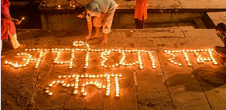 Devotees light earthern lamps during Ganga 'aarti' at Dashashmedh Ghat, ahead of the foundation laying ceremony of Ram Temple in Ayodhya, in Varanasi, Sunday, Aug. 2, 2020. Credit: PTI Photo