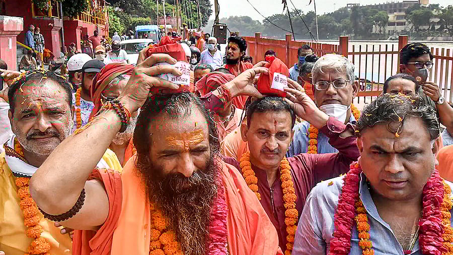 Mahant Ravinder Puri and other seers carry water collected from the Ganges as they depart for Ayodhya for the foundation laying ceremony of Ram temple, in Haridwar. Credits: PTI Photo