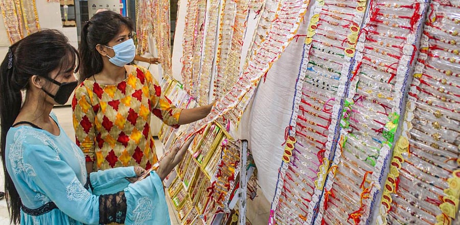 Women purchase 'rakhi' ahead of Raksha Bandhan festival at Sadar Bazaar, in Gurugram. Credit: PTI Photo