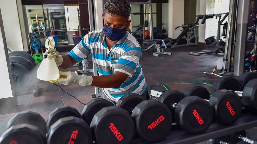 <div class="paragraphs"><p> A worker sprays disinfectants on gym equipment. (Representative image)</p></div>