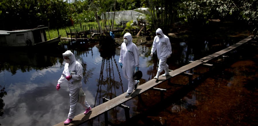 Healthcare workers as they visit riverside communities to check on residents during the coronavirus disease. Credit: Reuters