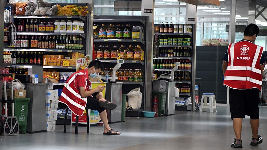 Vendors wait for customers at a store which opened on a trial basis at the Xinfadi wholesale market in Beijing. Credits: AFP Photo