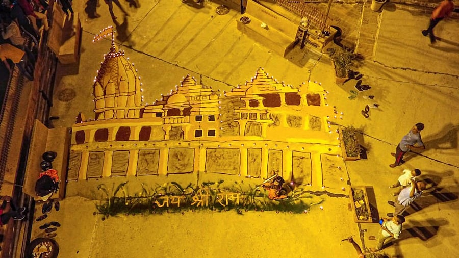 Vishva Hindu Parishad (VHP) and Bajrang Dal members make a replica of Ram temple using gulal and earthen lamp. Credit: PTI