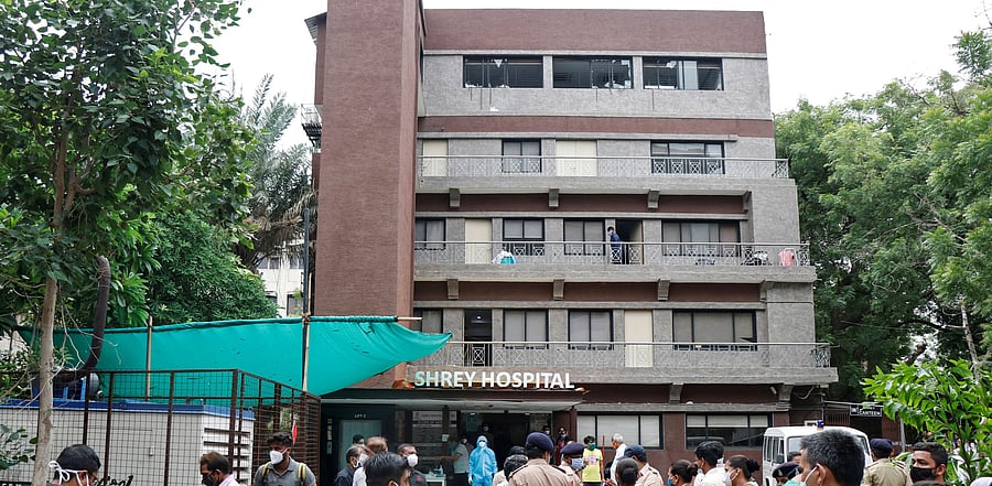 Police officers and relatives stand outside a hospital where a fire broke out inside an intensive Care Unit (ICU) treating patients infected with the coronavirus disease (COVID-19) in Ahmedabad. Credit: Reuters