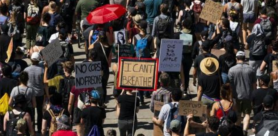 Protesters march to City Hall in support of defunding police. Credit: AFP Photo