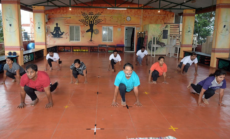 A team, led by GSS Yoga Institute head D Srihari, performs yoga, at the institute in Mysuru on Wednesday. DH PHOTO