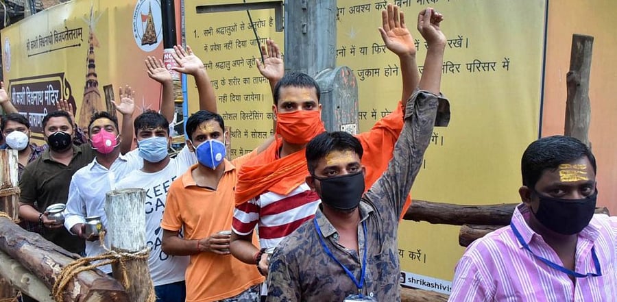 Devotees wait to perform 'abhishek' of Lord Shiva at the Kashi Vishwanath temple. Credit: PTI
