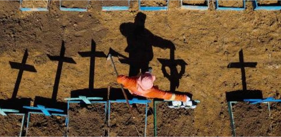 A gravedigger standing at the Nossa Senhora Aparecida cemetery where Covid-19 victims are buried daily, in the neighbourhood of Taruma, in Manaus, Brazil. Credit: AFP Photo
