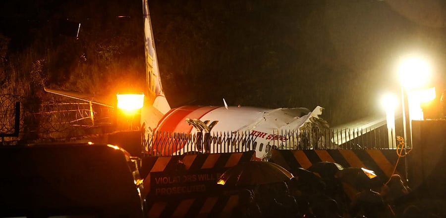 Mangled remains of an Air India Express flight en route from Dubai after it skidded off the runway while landing, at Karippur in Kozhikode. Credit: PTI