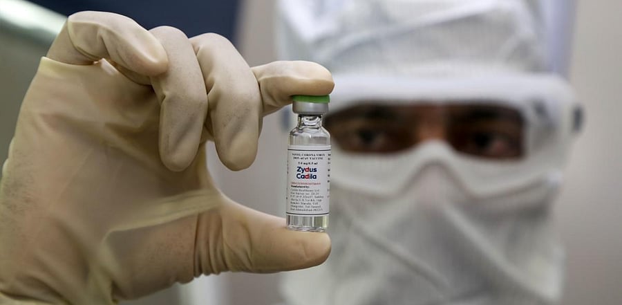 A pharmaceutics worker shows a shot of a vaccine tested by Zydus Cadila to treat the coronavirus. Credit: AFP
