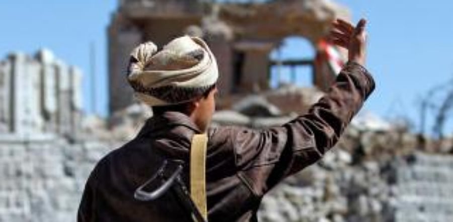 An armed Yemeni man looks at the debris following an airstrike by the Saudi-led coalition on the guard house of a memorial to Egyptian soldiers in the southern Sanaa neighbourhood of Aser. Credit: AFP Photo