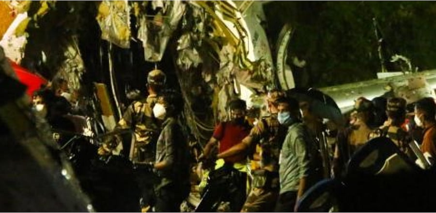 First responders inspect the wreckage of an Air India Express jet, which was carrying more than 190 passengers and crew from Dubai, after it crashed by overshooting the runway at Calicut International Airport in Karipur, Kerala. Credit: AFP Photo