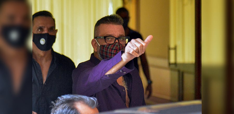 Bollywood actor Sanjay Dutt waves as he returns home after being discharged from a hospital in Mumbai on August 10, 2020. Credit: AFP Photo