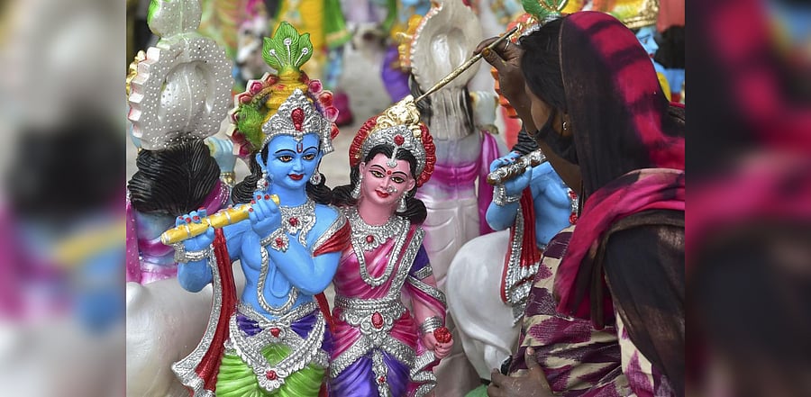 An artist gives final touches to Krishna idols ahead of Janmashtami festival. Credit: PTI