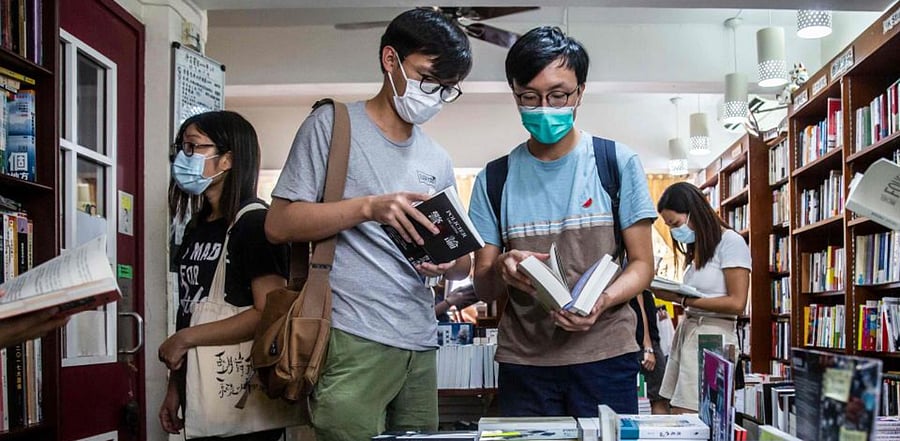 Customers browsing in a bookstore in Hong Kong that stocks books with sensitive political titles that could potentially contravene the new national security law. Credit: AFP Photo