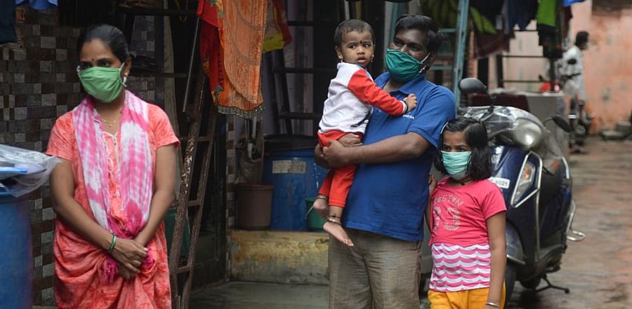 Residents wait to get themselves checked during coronavirus screening. Credit: AFP