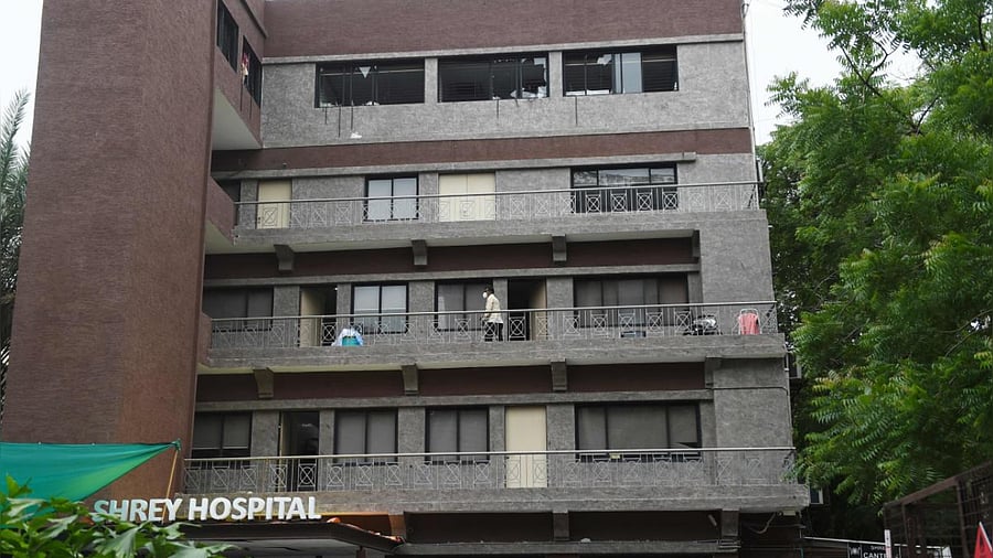 Broken glass windows are seen at the top floor of the Shrey Hospital. Credits: DH Photo