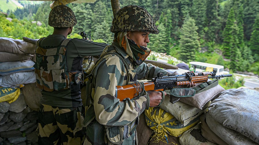 Border Security Force (BSF) personnel stand guard along the Srinagar-Leh National highway, in Ganderbal district of Central Kashmir. Credits: PTI Photo