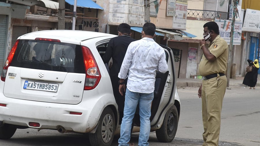 Police detain a man suspected to be involved in the Bengaluru riots, on Friday. DH PHOTO/S K DINESH