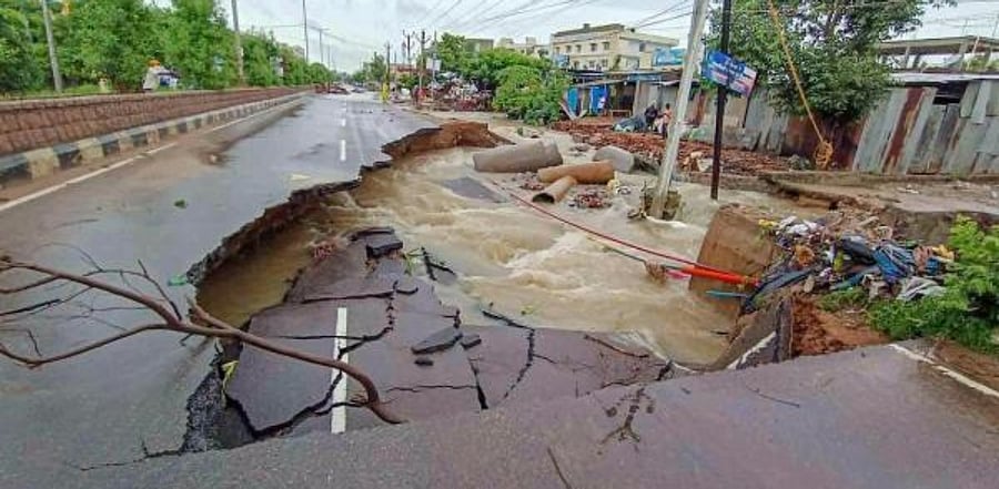 A portion of a road washed away after heavy rainfall. Credit: PTI