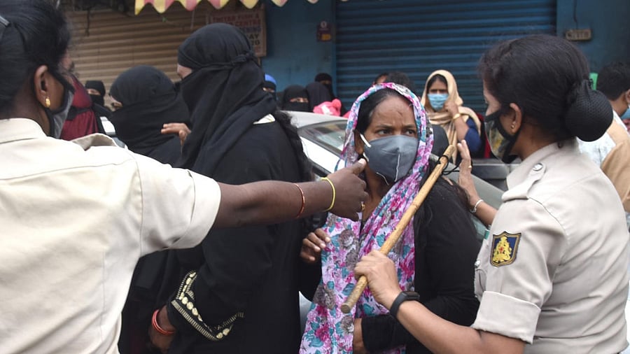 Policewomen shoo away the protesters on Sunday. DH PHOTO/S K DINESH