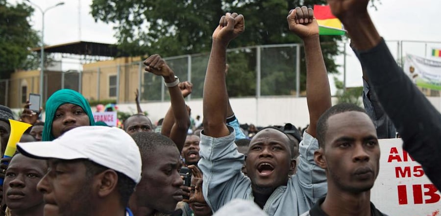 A man cheers during a protest organised by M5-RFP, who are calling for Malian President Ibrahim Boubacar Keita to resign, in Bamako. Credit: AFP Photo