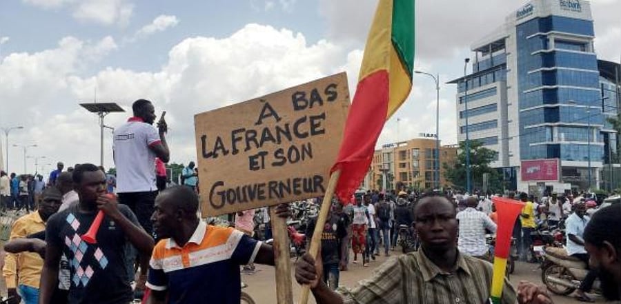 Opposition supporters react to the news of a possible mutiny of soldiers in the military base in Kati, outside the capital Bamako. Credit: Reuters
