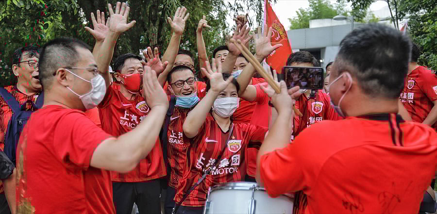 This file photo taken on July 27, 2020 shows fans of Shanghai SIPG cheering for their team before the Chinese Super League (CSL) football match between Shanghai SIPG and Tianjin Teda. Credit: AFP Photo