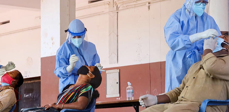 Health workers collect samples from corporation workers for Covid-19 test, during Unlock 2.0, at a school in Kozhikode, Thursday, July 30, 2020. Credit: PTI Photo