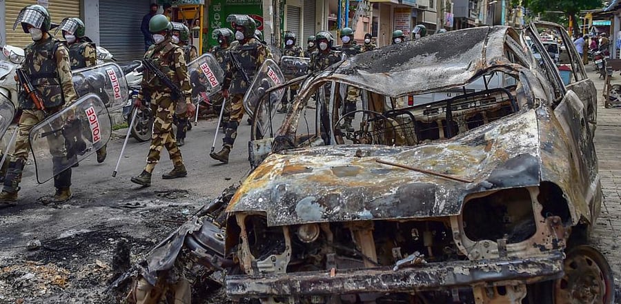 Security personnel carry out a flag march in the riot-hit area after a mob went on a rampage on Tuesday over a social media post, allegedly posted by a Congress MLA's relative, in Bengaluru, Thursday, Aug. 13, 2020. Credit: PTI Photo