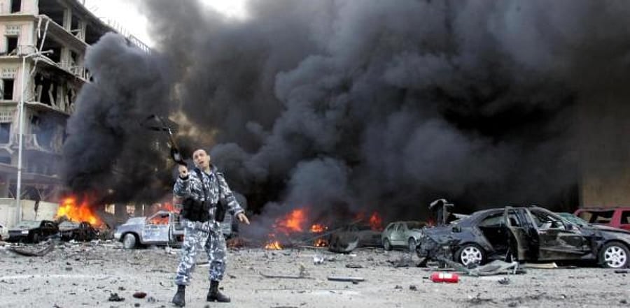A Lebanese police officer gestures on the site of an explosion. Credit: AFP