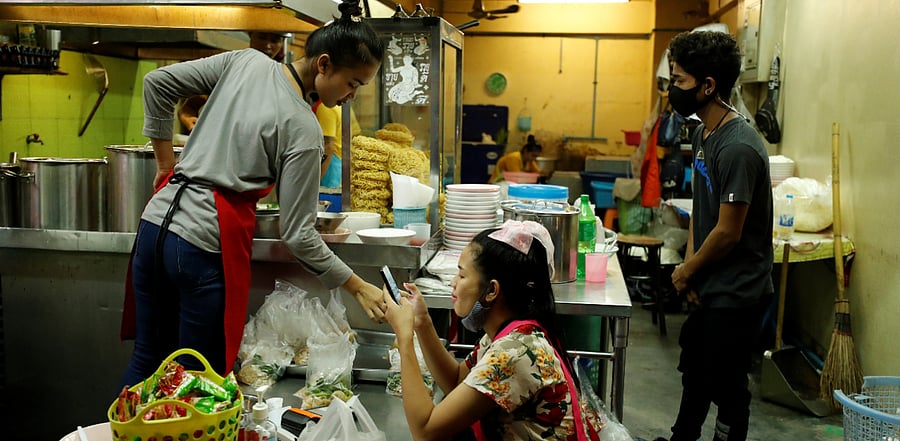 People work in a noodle shop as the global spread of the Covid-19 continues, in Bangkok, Thailand. Credit: Reuters Photo